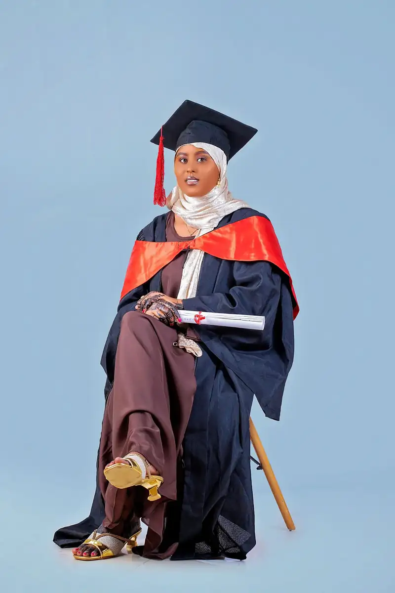 Graduate in academic dress, outdoors. Stock photo from Pexels, not a Nafasi student.